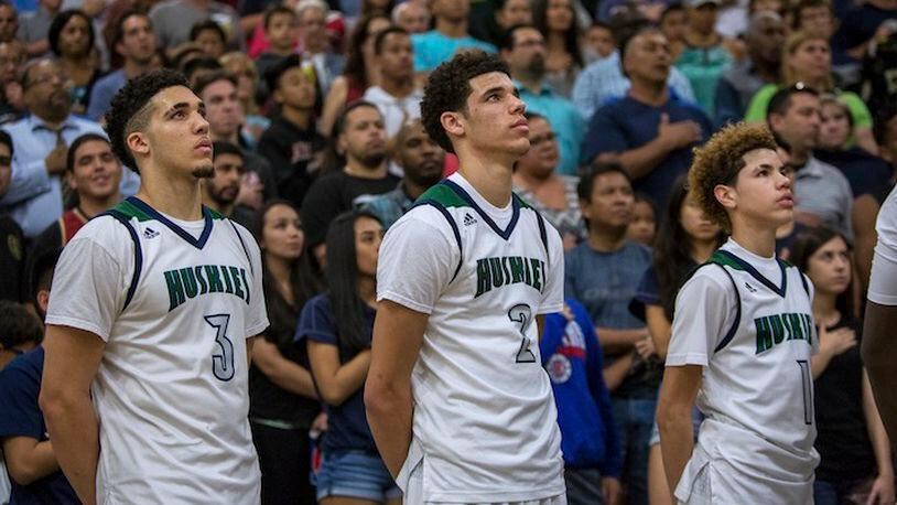 The sibling stars of Chino Hills High, from left: LiAngelo, Lonzo and LaMelo Ball, before a home game in Chino Hills, Calif., Feb. 10, 2016. Playing a full-time, full-court press and averaging almost 100 points a game, the 27-0 Huskies are the top-ranked team in the nation, and all three Ball brothers have committed to play at UCLA. (Monica Almeida/The New York Times)