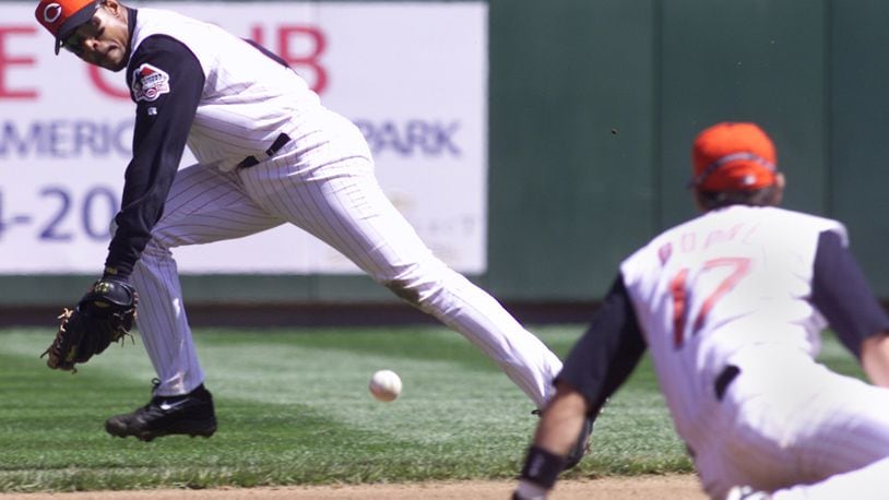 Barry Larkin, the Cincinnati Reds shortstop, goes for a ball that Aaron Boone (right) couldn't get against the Montreal Expos in this file photo.