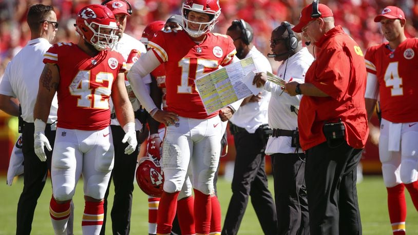 KANSAS CITY, MO - SEPTEMBER 23: Patrick Mahomes #15 of the Kansas City Chiefs and teammate Anthony Sherman #42 stand with head coach Andy Reid and offensive coordinator Eric Bieniemy in the fourth quarter of the game against the San Francisco 49ers at Arrowhead Stadium on September 23rd, 2018 in Kansas City, Missouri. (Photo by David Eulitt/Getty Images)