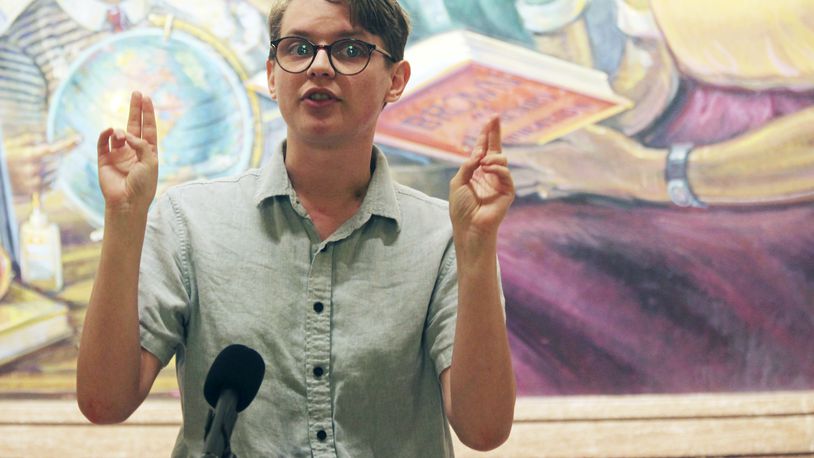 Isaac Johnson, who just completed an internship with Topeka's public schools and is finishing work on a social work degree, talks to reporters during a news conference, Thursday, April 26, 2024, in front of a mural at the Statehouse in Topeka, Kan. Johnson, who is transgender, worries about the effects of a proposed ban on gender-affirming care for minors, which also would bar state employees from promoting social transitioning for youth. (AP Photo/John Hanna)