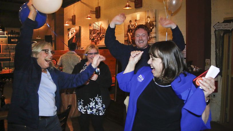 Carolyn Rice, right, a Democrat and current Montgomery County treasurer, celebrates her election Tuesday as a Montgomery County commissioner. TY GREENLEES / STAFF