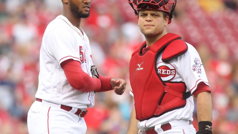 Reds pitcher Amir Garrett and Devin Mesoraco pause after Garrett was hit on the hand by a groundball during a game against Indians on Tuesday, May 23, 2017, at Great American Ball Park in Cincinnati. David Jablonski/Staff
