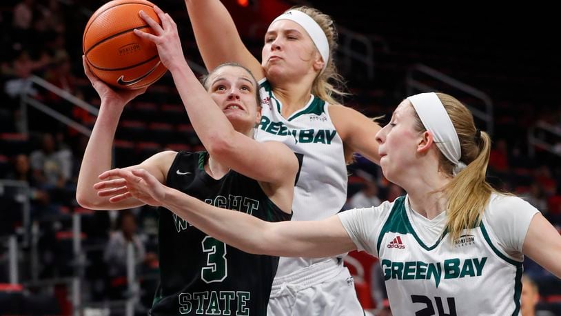 Wright State guard Emily Vogelpohl (3) drives on Green Bay guard Allie LeClaire (24) and Jessica Lindstrom during the first half of an NCAA women’s basketball game in the Horizon League conference tournament championship in Detroit, Tuesday, March 6, 2018. (AP Photo/Paul Sancya)