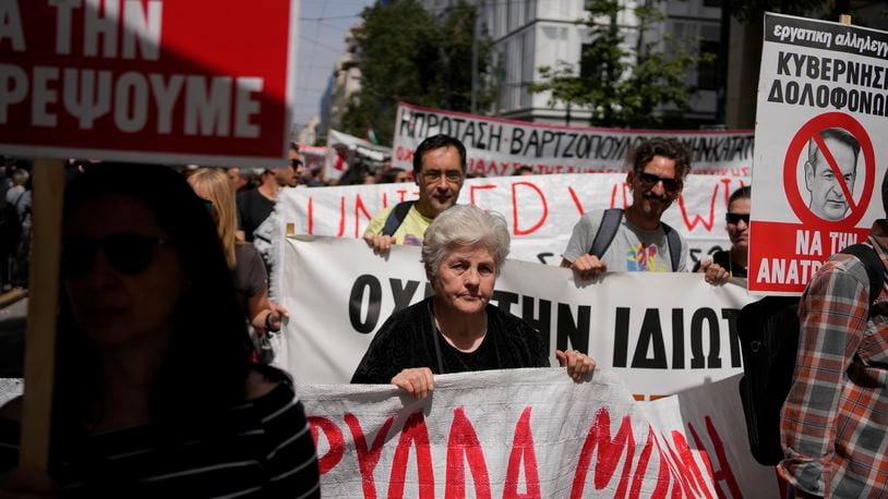 Protesters hold banners during a rally in Athens, Greece, Wednesday, April 17, 2024. A 24-hour strike called by Greece's largest labor union have halted ferries and public transport services in the Greek capital and other cities, to press for a return of collective bargaining rights axed more than a decade ago during a severe financial crisis. (AP Photo/Thanassis Stavrakis)