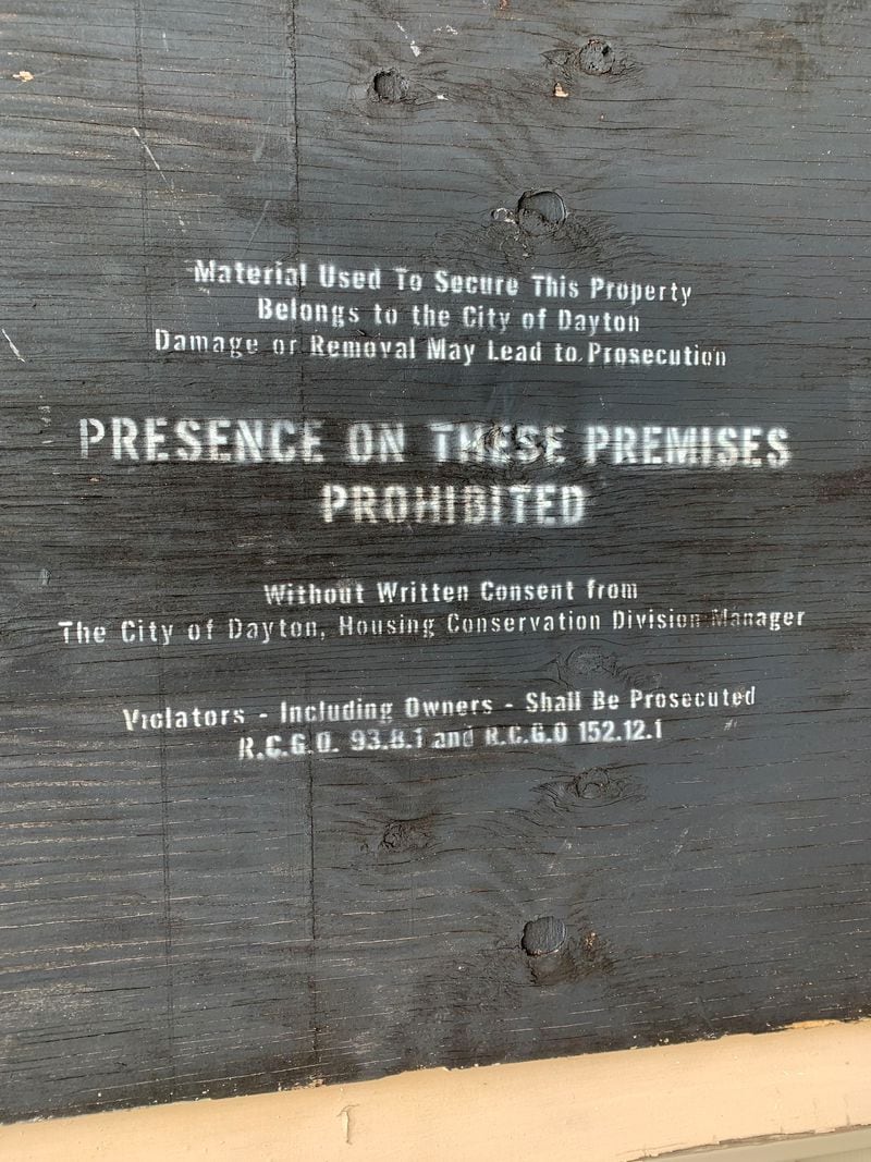 A sign over the garage of a home on Wheatley Avenue says presence is prohibited. The owner of the home received $11,500 last year through a rental assistance program funded with federal CARES Act money. The property did not have water last year.