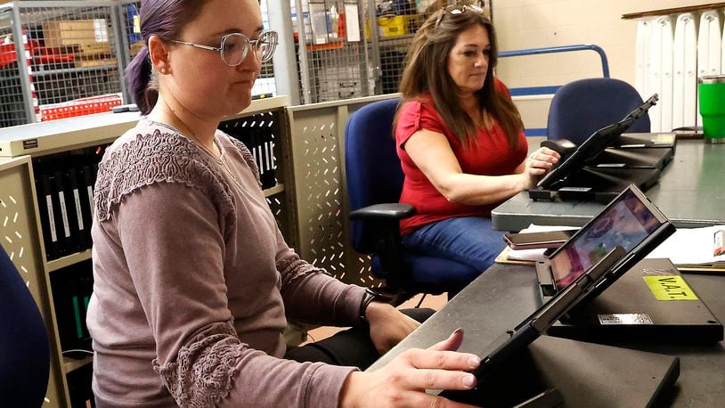Brittany Kensler, left, and Pattie Fuschino were busy updating the epoll books for the upcoming election Thursday, April 6, 2023, at the Clark County Board of Elections. BILL LACKEY/STAFF