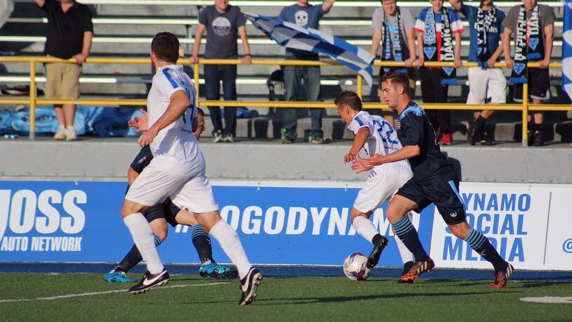 Dan Dwyer of the Dayton Dynamo pushes the ball up the field during a game at Welcome Stadium last season. TODD JACKSON/STAFF