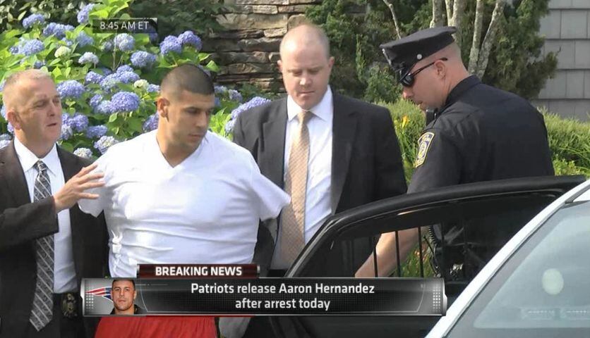 Police escort Aaron Hernandez from his home in handcuffs