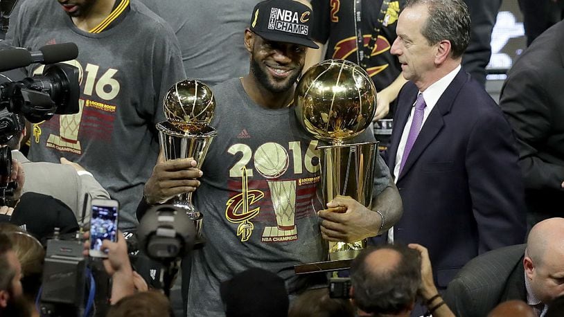 OAKLAND, CA - JUNE 19: LeBron James #23 of the Cleveland Cavaliers holds the Larry O'Brien Championship Trophy and the Bill Russell NBA Finals Most Valuable Player Award after defeating the Golden State Warriors 93-89 in Game 7 of the 2016 NBA Finals at ORACLE Arena on June 19, 2016 in Oakland, California. NOTE TO USER: User expressly acknowledges and agrees that, by downloading and or using this photograph, User is consenting to the terms and conditions of the Getty Images License Agreement. (Photo by Ronald Martinez/Getty Images)
