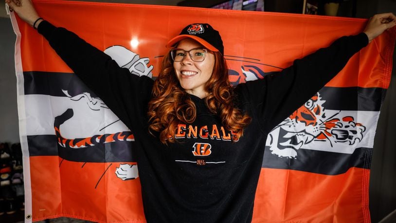 Cincinnati Bengals fan extraordinaire Alexandra Farmer wears a sweatshirt once worn by her Bengals-fan great grandmother, a shirt she wears each Sunday in her memory while rooting on the team. Farmer said she is optimistic about the team beating the Las Vegas Raiders in Wild Card Round of the AFC playoffs. JIM NOELKER/STAFF
