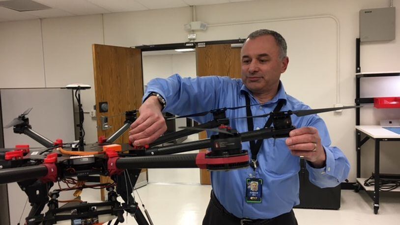 Andy Jones, senior program manager at defense contractor MacAulay-Brown Inc., adjusts one of the company’s unmanned aerial vehicles at the company’s Beavercreek’s offices. THOMAS GNAU/STAFF