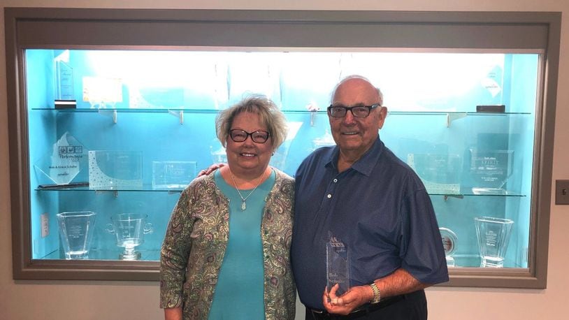 President Carol Russell and Founder Bob Schulte holding the 40-Year Anniversary trophy for Spherion Staffing. Contributed photo