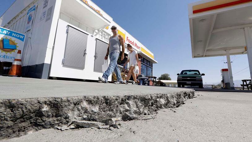 A crack is seen in a gas station's driveway in the aftermath of an earthquake Saturday, July 6, 2019, in Trona, Calif. Crews in Southern California assessed damage to cracked and burned buildings, broken roads, leaking water and gas lines and other infrastructure Saturday after the largest earthquake the region has seen in nearly 20 years jolted an area from Sacramento to Las Vegas to Mexico. (AP Photo/Marcio Jose Sanchez)