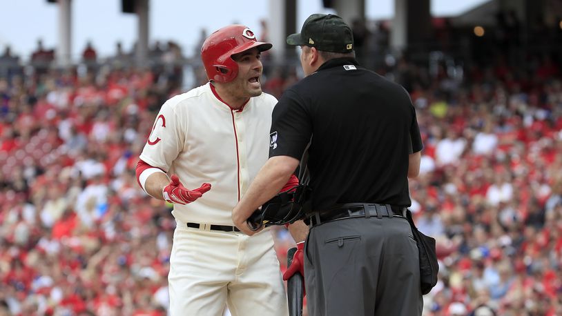 CINCINNATI, OHIO - MAY 19: Joey Votto #19 of the Cincinnati Reds has words with home plate umpire Dan Bellino after striking out in the first inning against the Los Angeles Dodgers at Great American Ball Park on May 19, 2019 in Cincinnati, Ohio. (Photo by Andy Lyons/Getty Images)