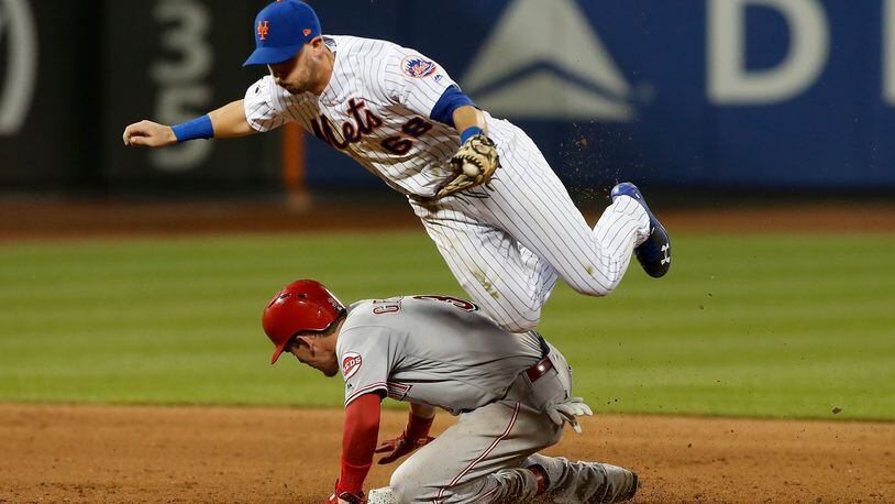 NEW YORK, NY - AUGUST 06:  Jeff McNeil #68 of the New York Mets gets a force out at second base against Scooter Gennett #3 of the Cincinnati Reds during the sixth inning at Citi Field on August 6, 2018 in the Flushing neighborhood of the Queens borough of New York City.  (Photo by Jim McIsaac/Getty Images)