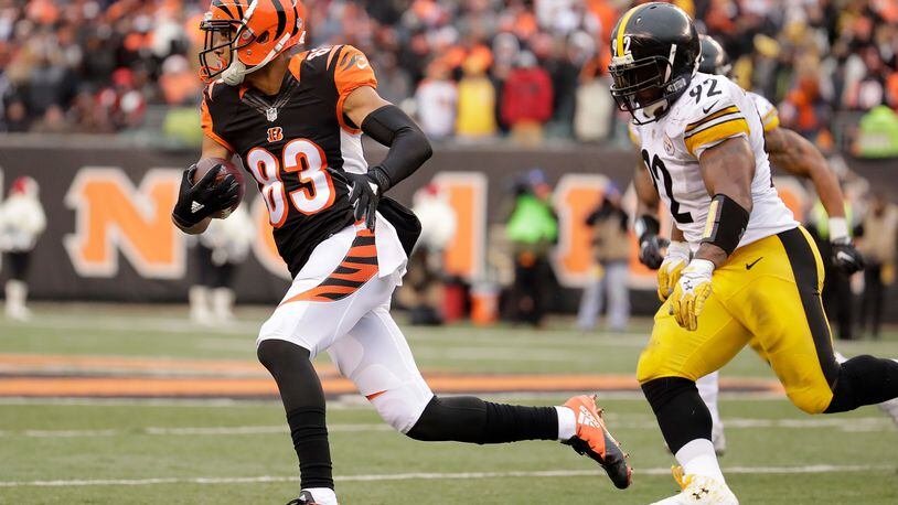 CINCINNATI, OH - DECEMBER 18: Tyler Boyd #83 of the Cincinnati Bengals runs the ball away from James Harrison #92 of the Pittsburgh Steelers during the third quarter at Paul Brown Stadium on December 18, 2016 in Cincinnati, Ohio. (Photo by Andy Lyons/Getty Images)