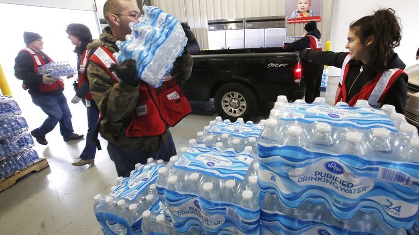 Free water distribution continued at The Foodbank in Dayton on Friday as the City entered its second day of a boil advisory after a water main break on Wednesday. TY GREENLEES / STAFF