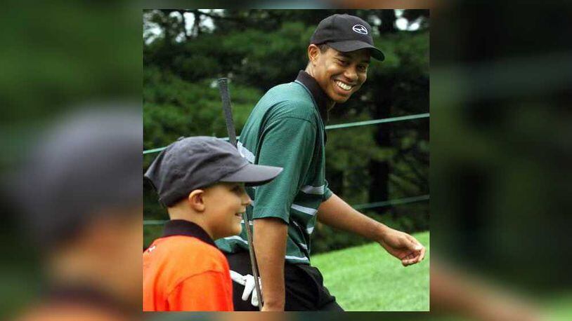 Stalking the Firestone Country Club with his favorite golfer, Tiger Woods, Dan Herchline (11) of Beavercreek got his special wish today. The young man has leukemia and his wish was to walk the course with Tiger on Aug. 25, 1999. Bill Reinke/Dayton Daily News