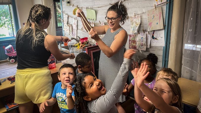 Rainbow Years Child Care Center teachers Abbie Beirise and Heather Simonds use bubbles to get the children to use their whole bodies before lunch Friday June 4, 2021. JIM NOELKER/STAFF