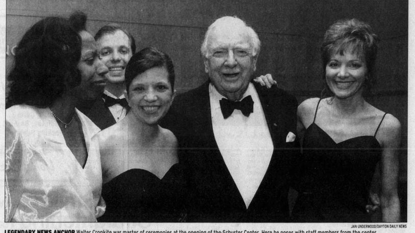 Legendary news anchor Walter Cronkite was master of ceremonies at the opening of the Schuster Center. Here he poses with staff members from the center. DAYTON DAILY NEWS ARCHIVES.
