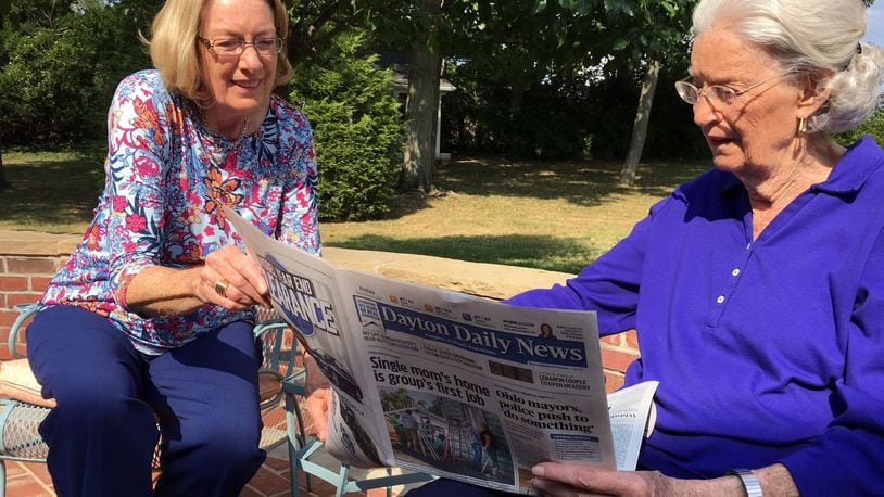 Dayton Daily News Lifelong Subscribers Kathy Kavanaugh, 71, and Ginny Whalen, 95, on the back patio of Whalen’s Kettering home