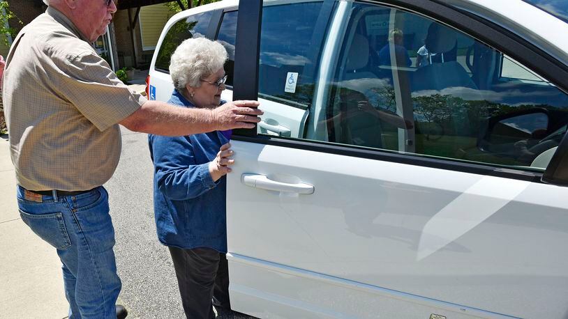 Larry Brooks, a driver with Central Connections, helps Wanda Coffey, a volunteer for Hospice Care of Middletown, get in one of their transportation vans for a ride home from the senior center in Middletown. Middletown voters will decide on a senior services renewal levy this spring. STAFF FILE/2016