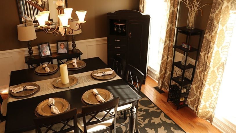 Wainscoting and a contemporary chandelier add a touch of elegance in the dining room.