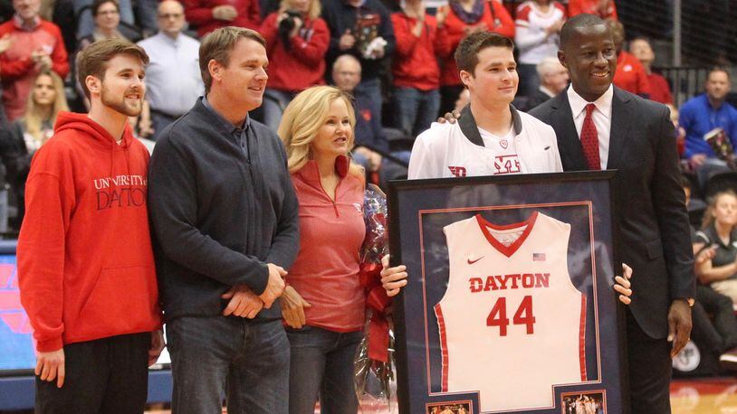 Dayton’s Joey Gruden, second from left, stands with coach Anthony Grant, right, and (left to right) his brother Jack, father Jay and mother Sherry during a Senior Day ceremony before a game against George Washington on Saturday, March 3, 2018, at UD Arena. David Jablonski/Staff