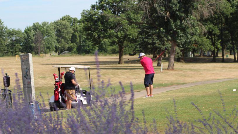 Golfers are shown at Kittyhawk Golf Center, part of Dayton’s golf system. CORNELIUS FROLIK / STAFF FILE