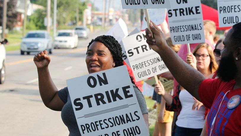 Members of the Professionals Guild of Ohio, which represents about 270 Montgomery County Children Services positions, picket outside the Haines Children’s Center on the first day of a strike Friday. CHRIS STEWART / STAFF