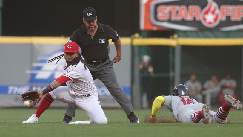 Reds second baseman Freddy Galvis takes a throw as the Cardinals’ Kolten Wong steals second base on Thursday, Aug. 15, 2019, at Great American Ball Park in Cincinnati. David Jablonski/Staff
