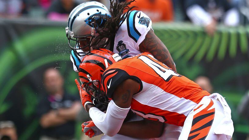 CINCINNATI, OH - OCTOBER 12: Kelvin Benjamin #13 of the Carolina Panthers is hit by George Iloka #43 of the Cincinnati Bengals while catching a pass for a touchdown during the first quarter at Paul Brown Stadium on October 12, 2014 in Cincinnati, Ohio. (Photo by Andy Lyons/Getty Images)