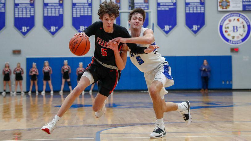 Franklin’s Noah Rich is guarded by Brookville’s Daniel Dominique during their game on Friday night in Brookville. The Wildcats won 56-47 to claim at least a share of the Southwestern Buckeye League Southwestern Division title. CONTRIBUTED PHOTO BY MICHAEL COOPER