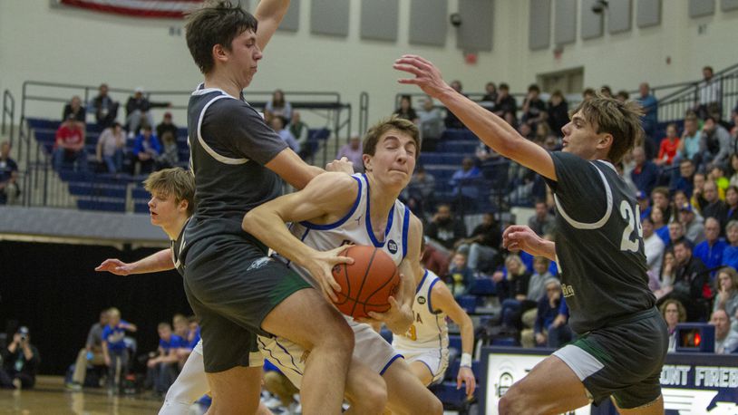 Russia's Benjamin York gets fouled on his way to the basket by Troy Christian's Frank Rupnik while Alex Free closes from the other side during Tuesday night's Division IV region semifinal at Trent Arena. CONTRIBUTED/Jeff Gilbert