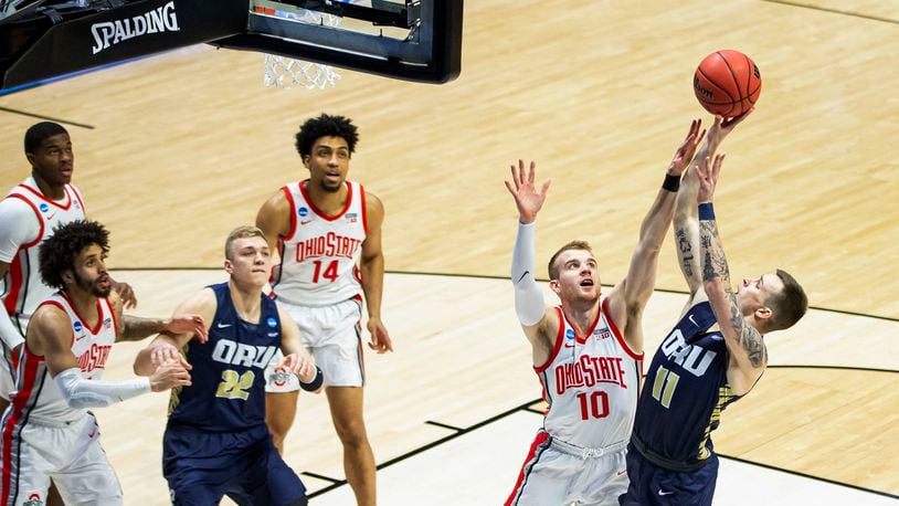 Oral Roberts' Carlos Jürgens (11) shoots over Ohio State's Justin Ahrens (10) during the first half of a First Round game in the NCAA men's college basketball tournament, Friday, March 19, 2021, at Mackey Arena in West Lafayette, Ind. (AP Photo/Robert Franklin)