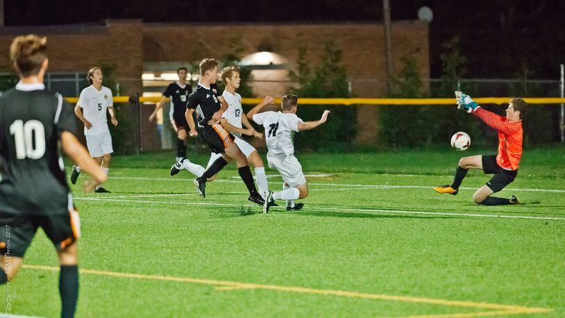 Beavercreek’s Hunter Jackson (6) attempts to score against Centerville as Elks defenders Alec Decuir (13) and Sam Haught (11) defend along with keeper Jonathan Huelsman. TINA HUELSMAN / CONTRIBUTED