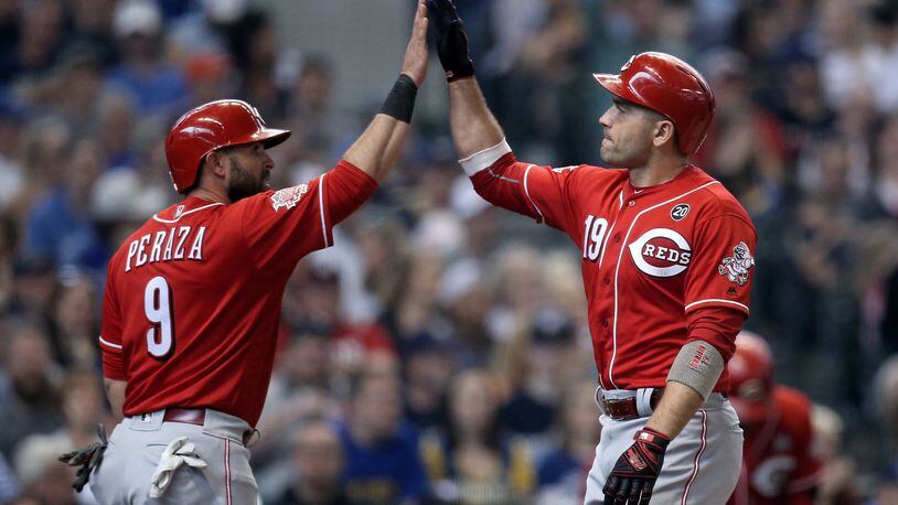 MILWAUKEE, WISCONSIN - JUNE 23: Jose Peraza #9 and Joey Votto #19 of the Cincinnati Reds celebrate after Votto hit a home run in the sixth inning against the Milwaukee Brewers at Miller Park on June 23, 2019 in Milwaukee, Wisconsin. (Photo by Dylan Buell/Getty Images)