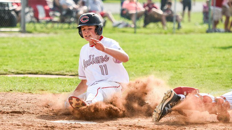 Carlisle’s Nolan Burney slides safely into home plate before the tag by Preble Shawnee catcher J.J. Hatmaker during Wednesday’s Division III sectional game at Sam Franks Field in Carlisle. NICK GRAHAM/STAFF
