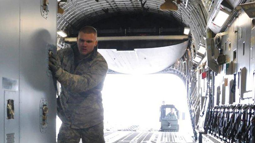 Staff Sgt. Dakota Coniglio, ramp operations specialist with the 87th Aerial Port Squadron, pushes an air transportable galley-lavatory onto a C-17 Globemaster III at Wright-Patterson Air Force Base. The ramp operations duty section works closely with the load planning duty section, both part of the aerial port squadron, to safely and quickly airlift cargo and people in support of the Air Force mission. (U.S. Air Force photo/1st Lt. Rachel Ingram)