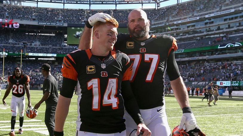 EAST RUTHERFORD, NJ - SEPTEMBER 11: Teammates Andy Dalton #14 and Andrew Whitworth #77 of the Cincinnati Bengals celebrate after a 23-22 victory over the New York Jets during their game at MetLife Stadium on September 11, 2016 in East Rutherford, New Jersey. (Photo by Streeter Lecka/Getty Images)