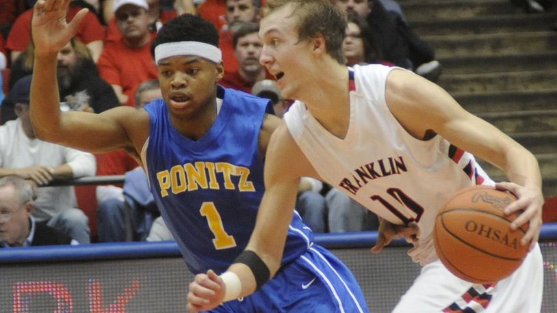 Franklin’s Luke Kennard (with ball) is covered by T’aundre Perkins of Ponitz. Franklin beat Ponitz 91-62 in a boys high school Division II sectional final that drew a sold-out crowd at UD Arena last Saturday. MARC PENDLETON / STAFF