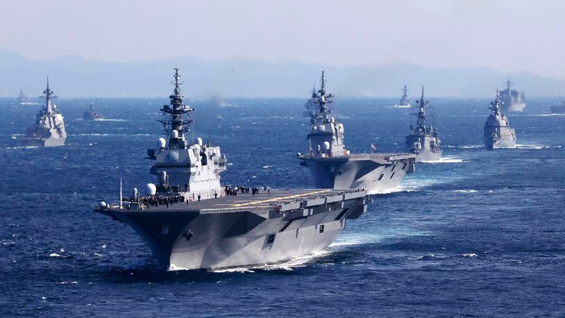 FILE - Japan's Maritime Self-Defense Force helicopter carrier JS Izumo, foreground, and other warships join an international fleet review in Sagami Bay, south of Tokyo, on Nov. 6, 2022. Japan’s defense chief has called for the bolstering of its anti-drone capability after a drone footage posted on a Chinese social media site showed a Japanese aircraft carrier docked at a restricted navy port west of Tokyo. (Kyodo News via AP, File)