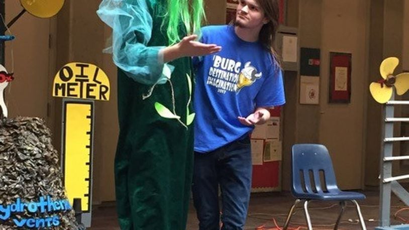 Miamisburg High School seniors Blake Boyd (left) and Brady Timpe compete in the scientific challenge at the 2017 state Destination Imagination tournament. Their team, also including Owen Clayton and Eliza Gauthier, won first place. They had to create a story — including a self-made gadget and a disguised character — about a secret mission, applying methods from cryptography and steganography to reveal secret messages. CONTRIBUTED PHOTO