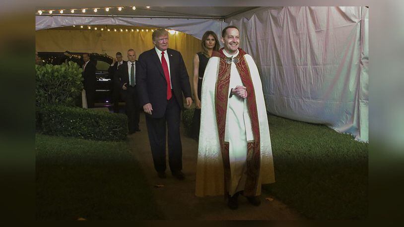 President Donald Trump and first lady Melania Trump are greeted by Rev. James Harlan before attending Christmas Eve service at Bethesda-by-the-Sea Sunday, December 24, 2017. (Damon Higgins / The Palm Beach Post)