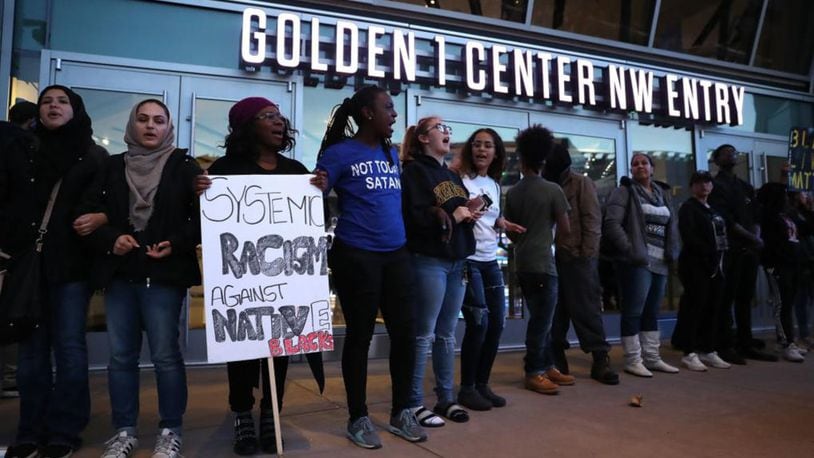 Protesters chant as they block the entrance to the Golden 1 Center during a demonstration Thursday in Sacramento, California.