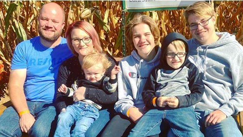 Paul Jewett, who died Saturday at 37 from Covid, with his wife and sons. PROVIDED