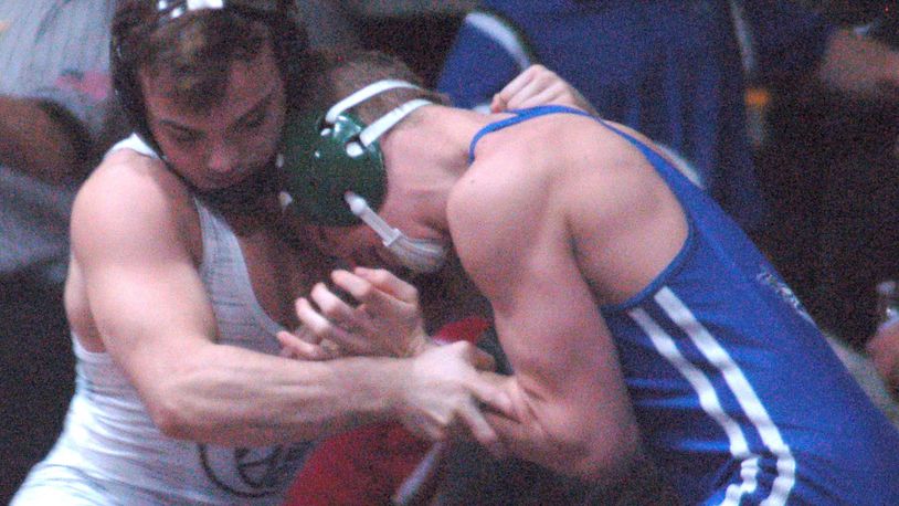 Graham’s Mitch Moore (left) locks up Chaminade Julienne’s Micah Marshall during the 145 pound final Thursday night in the GMVWA Holiday finals at Butler’s SAC. Moore claimed his fourth title with a fall in 2:59. John Cummings/CONTRIBUTED