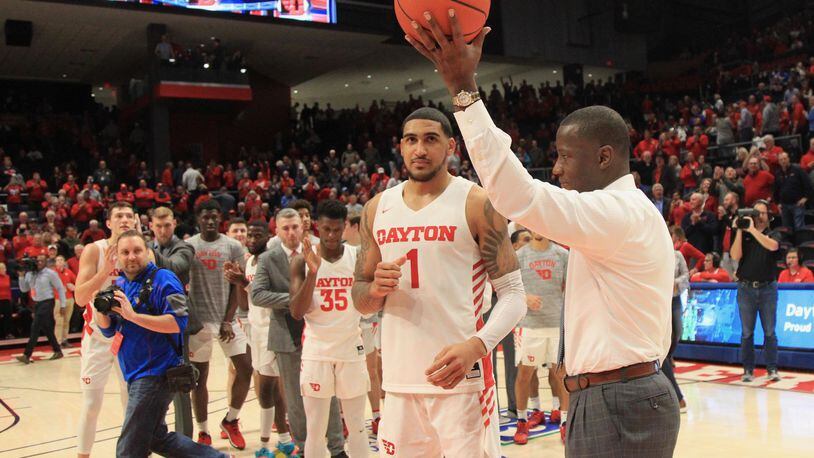 Dayton’s Anthony Grant honors Obi Toppin after a game against Duquesne on Saturday, Feb. 23, 2020, at UD Arena. Toppin was honored for scoring his 1,000th point in the game. David Jablonski/Staff