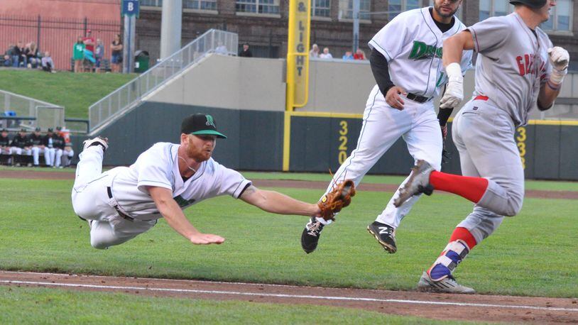 Dragons1: Dragons pitcher Andrew Jordan (left) attempts to tag Great Lakes runner Eric Peterson to record the first out of the fifth inning as John Sansone looks on during Dayton’s game against Great Lakes at Fifth Third Field on June 26, 2018. Nick Dudukovich/CONTRIBUTED