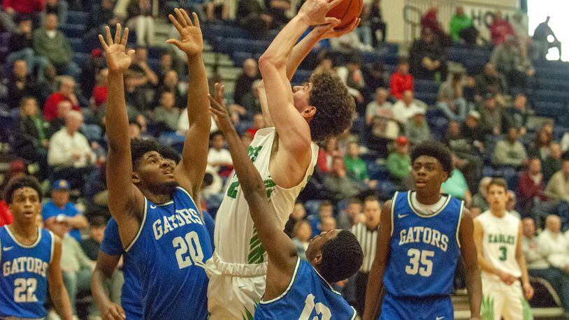 Chaminade Julienne’s Daniel Nauseef scores inside in the first half of Monday’s Flyin’ To The Hoop game at Trent Arena against Cincinnati Gamble Montessori’s DJ English (20) and Dalon Owesby (12). Jeff Gilbert/CONTRIBUTED
